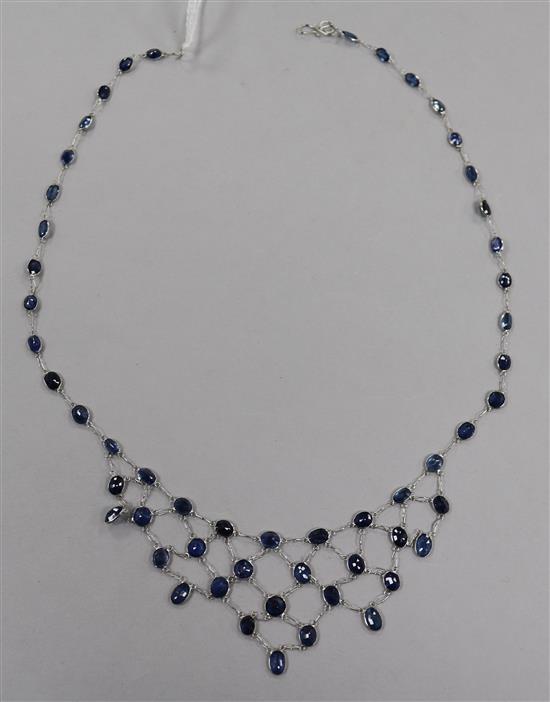 A modern 14ct white gold and sapphire set drop fringe necklace, 38cm.